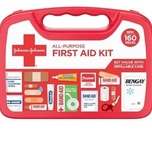 Red plastic emergency first aid kit displaying organized medical supplies and bandages.