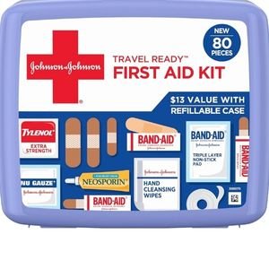 Compact blue travel first aid kit displaying various bandages and emergency medical supplies.