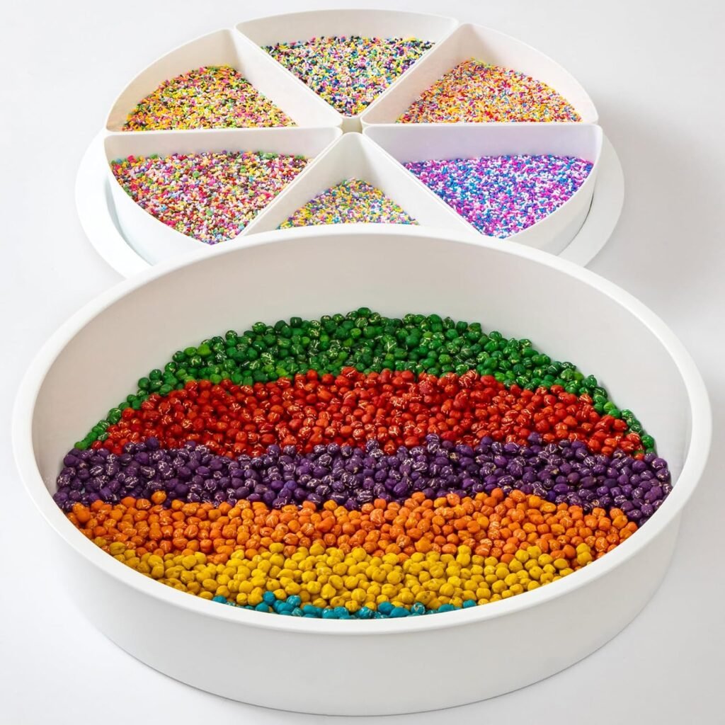 Compartmentalized sensory bin tray filled with colorful sorted rice grains and beads, featuring a central round section and removable divided lid segments.